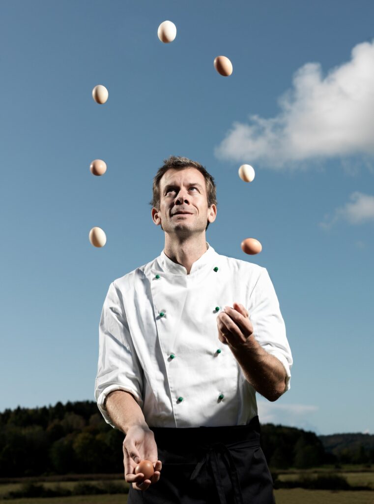 Chef juggling with eggs