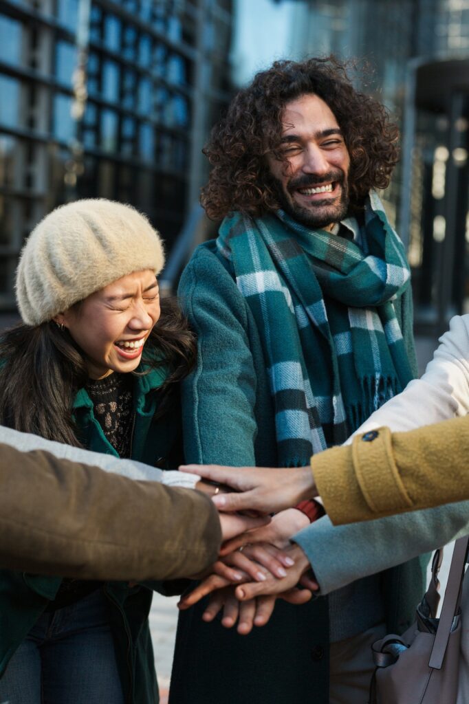 Group of business colleagues putting hands together outdoors