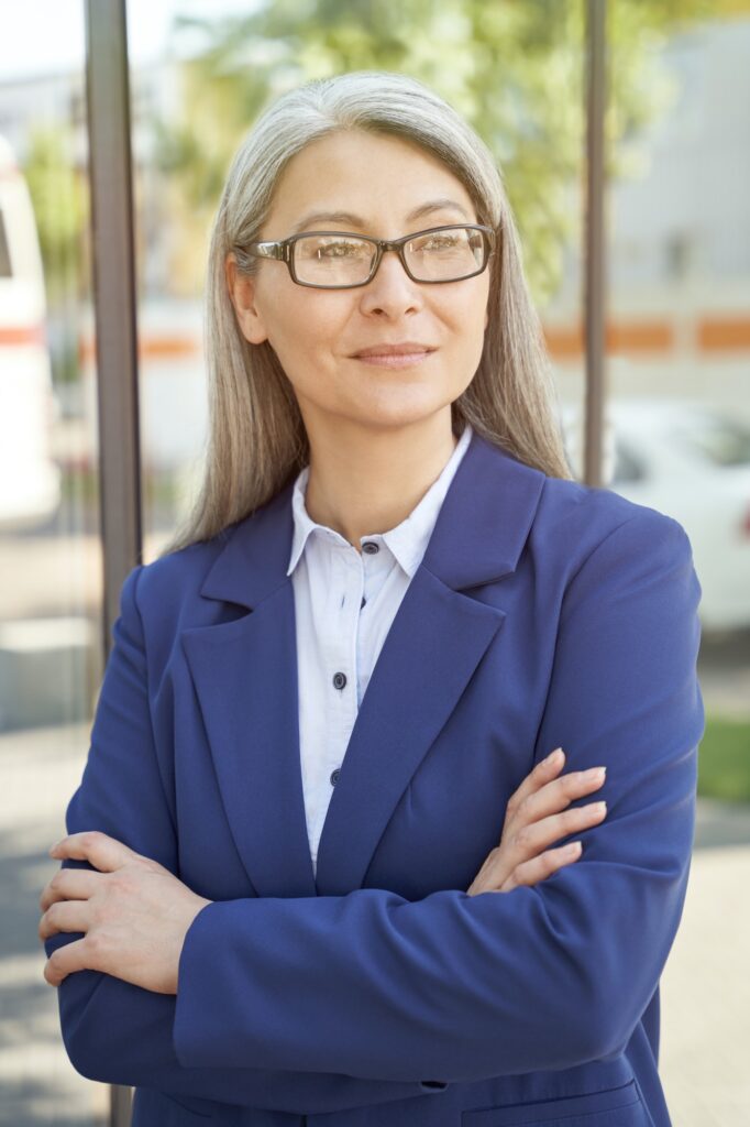 Portrait of confidence and success. Beautiful mature business woman wearing eyeglasses, looking