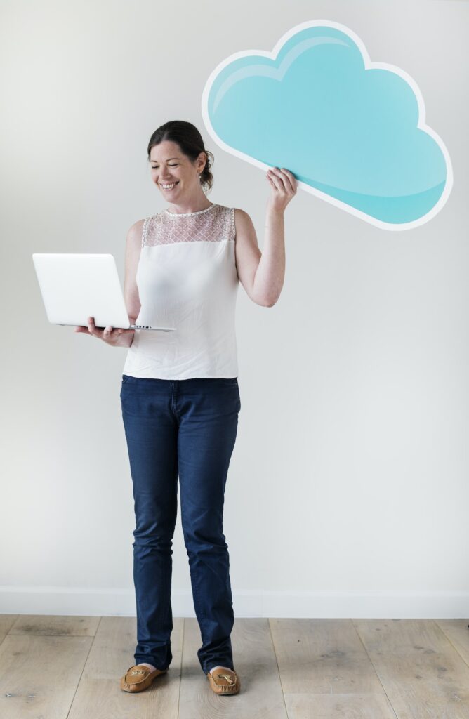 White woman using computer cloud network