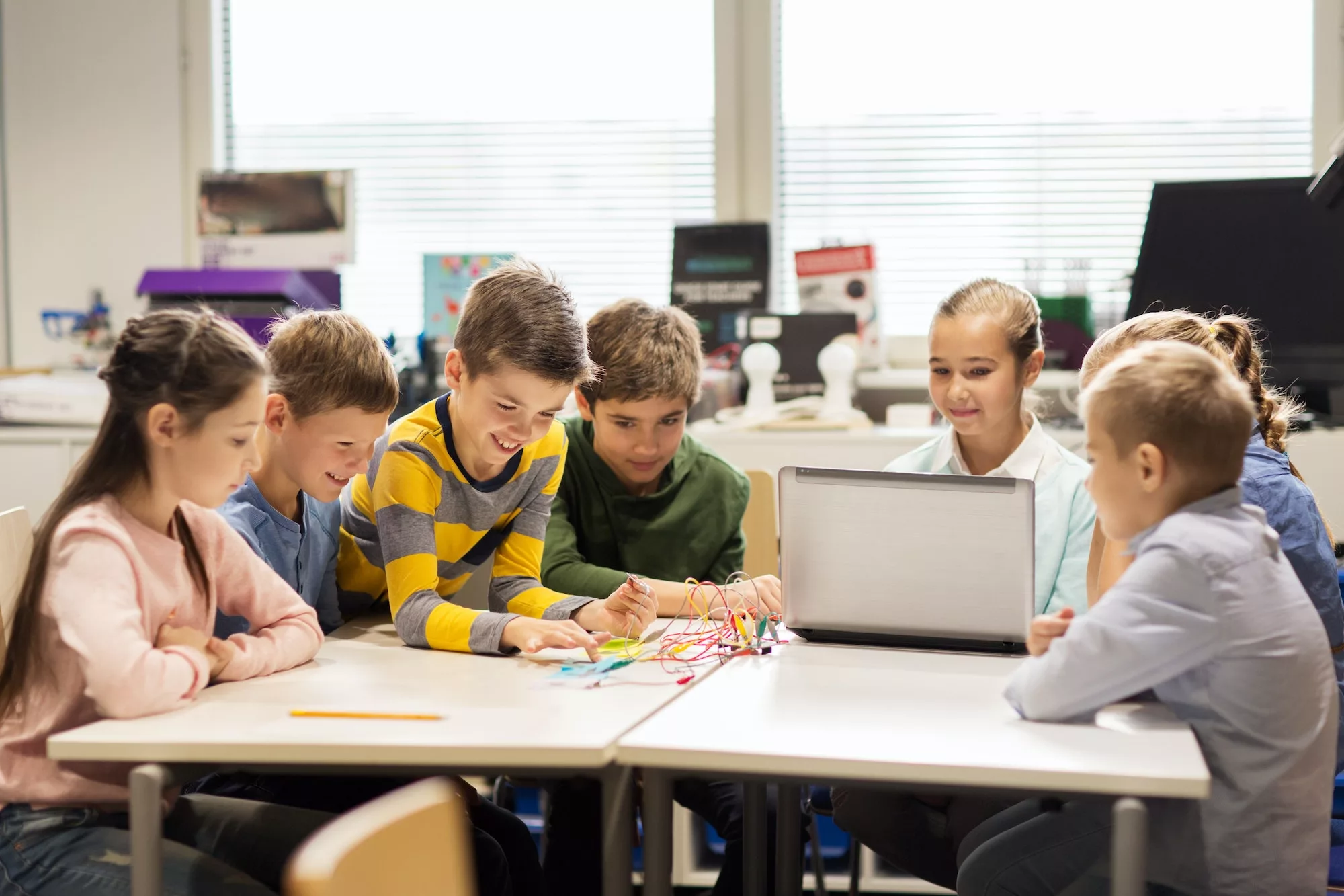 happy children with laptop at robotics school