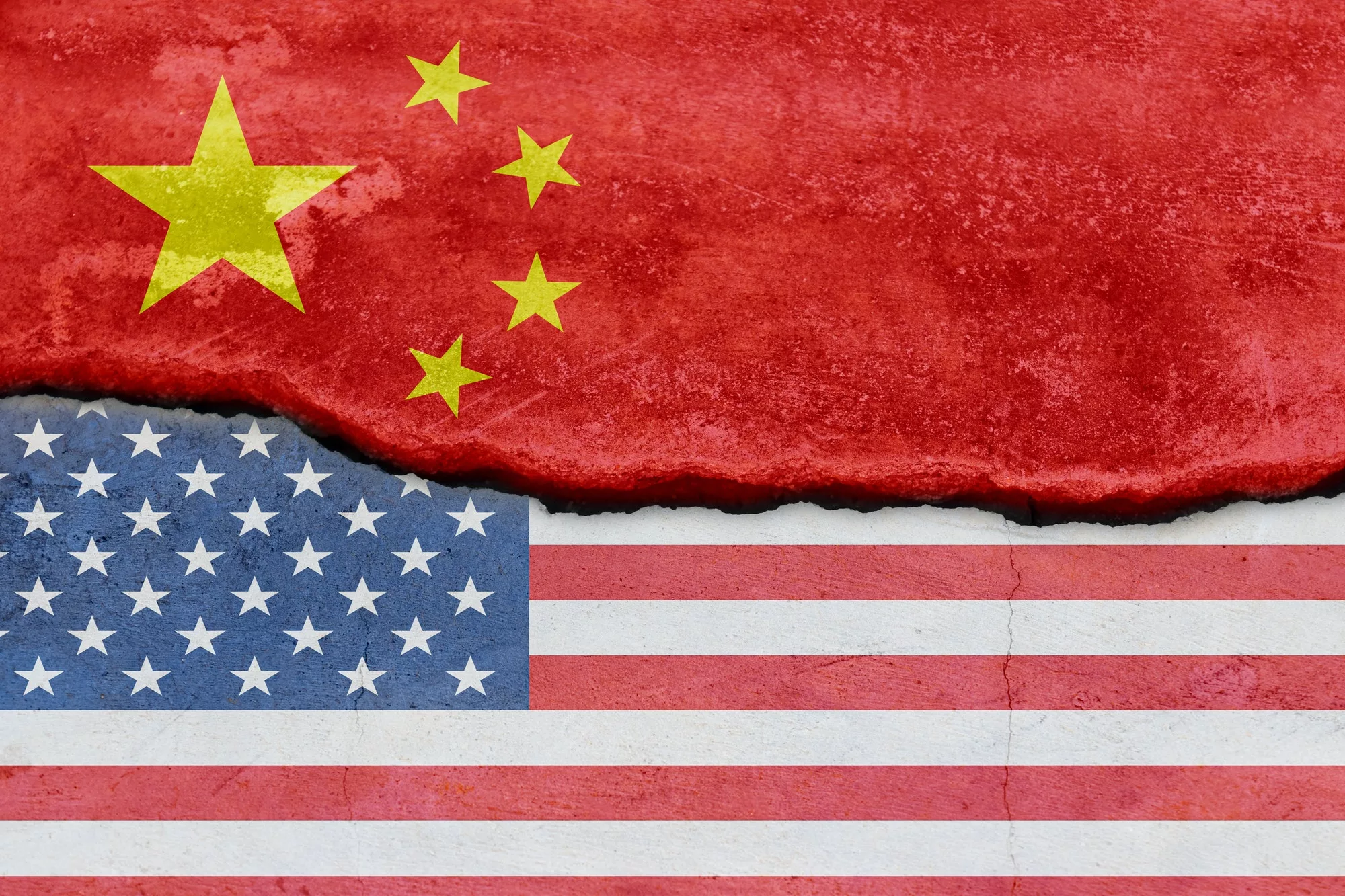 Flag of USA and China on cracked concrete wall background